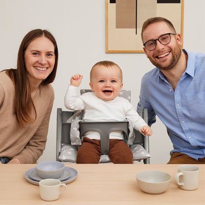 Un bébé qui est assis sur une chaise haute sur un coussin chaise haute