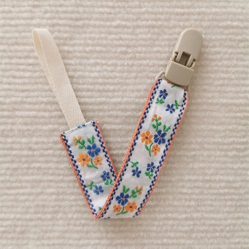 attache tetine fleur bleu orange