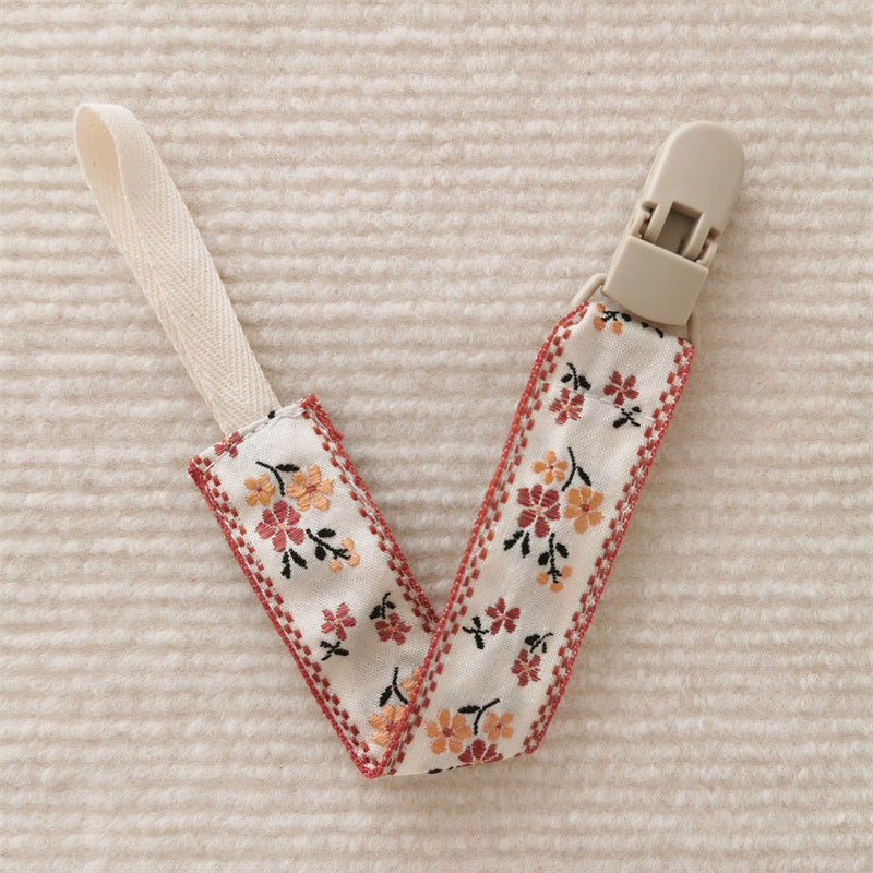 attache tetine fleur rouge orange